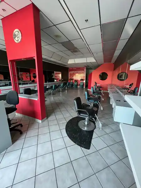 Main salon floor with styling stations along both walls